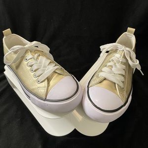 Metallic gold sneakers.